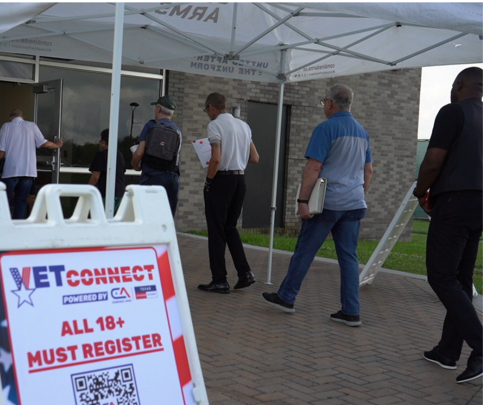 Alvin College Vetconnect with people walking by a VetConnect sign